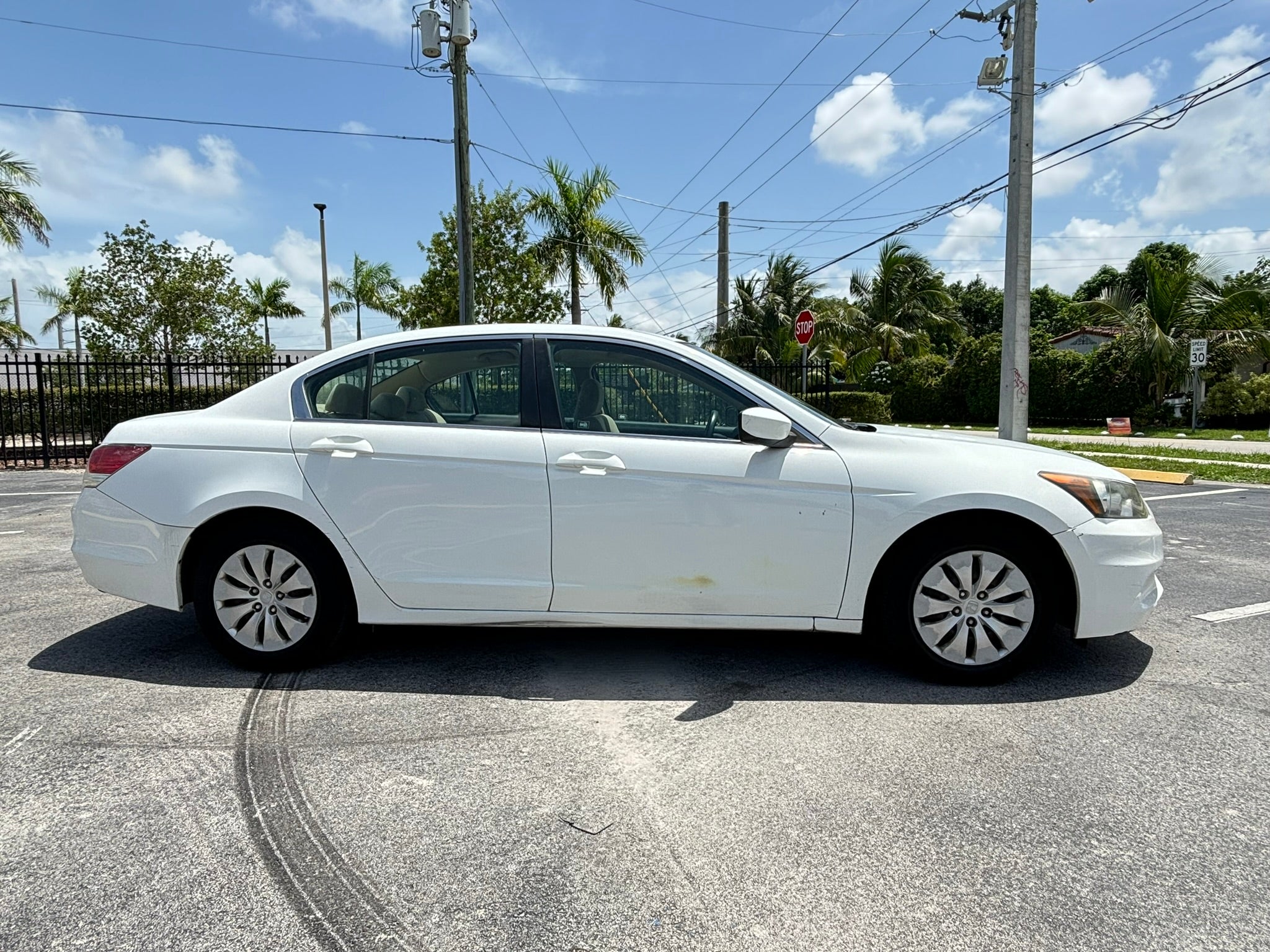 2012 Honda Accord LX – side profile view white rental sedan Florida