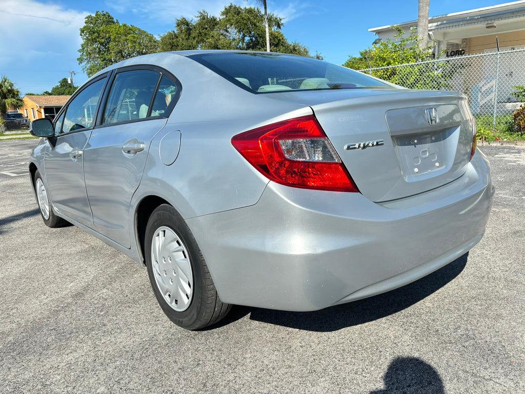 2012 Honda Civic LX – rear left angle, fuel-efficient rental sedan
