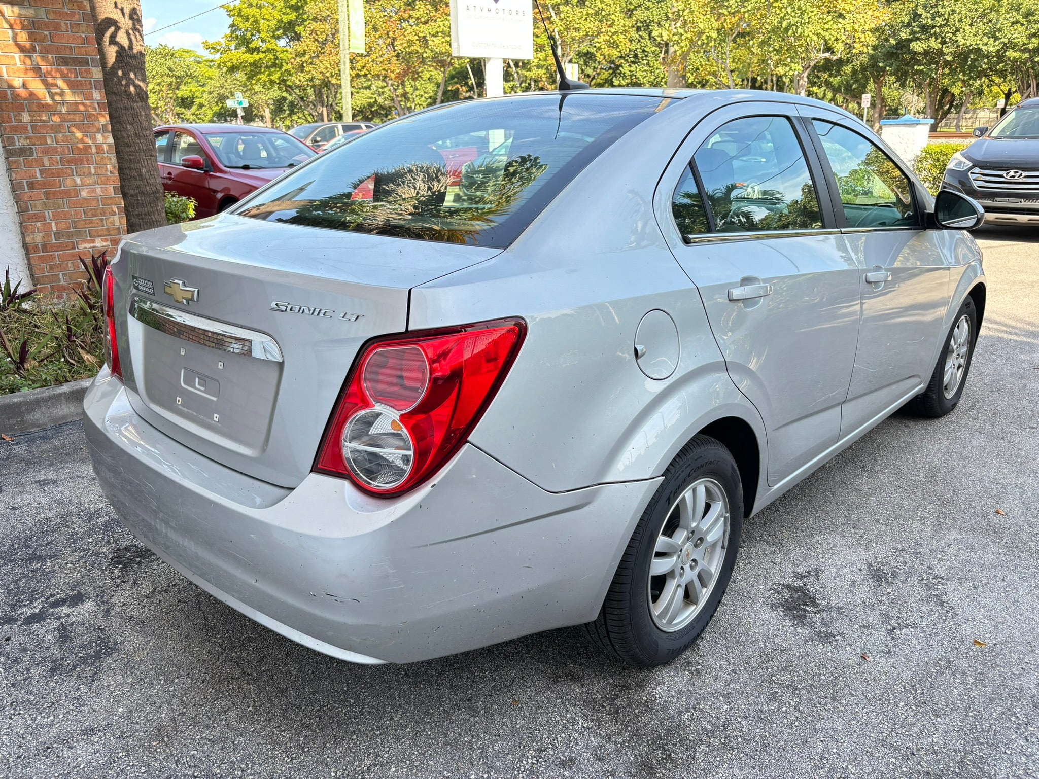 2012 Chevrolet Sonic LT – rear right angle, affordable rental car Florida